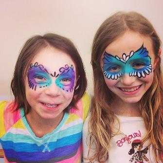 Girls at a fundraiser face painting
